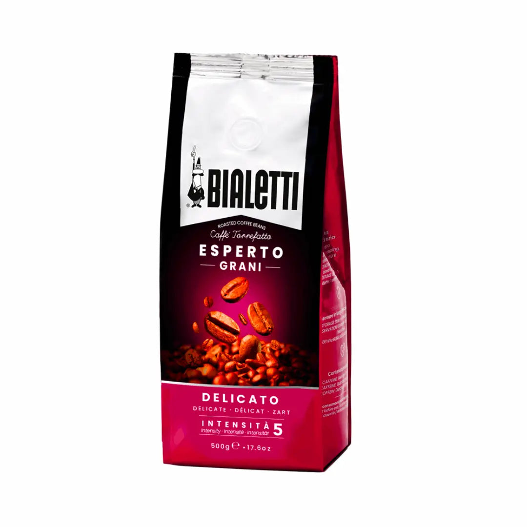 Bialetti Brew Italia Delicato whole bean coffee with medium roast, displayed in a clear glass jar on a wooden surface.