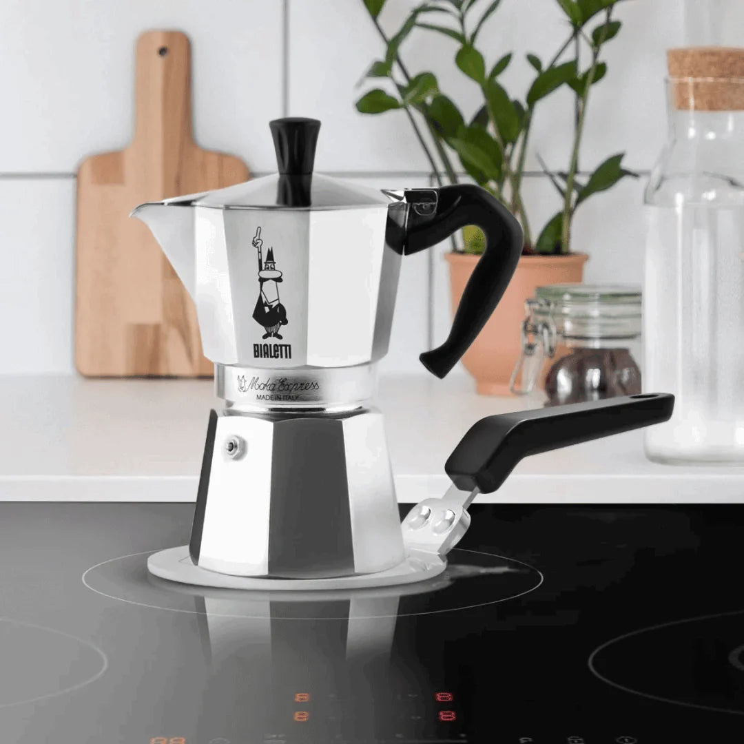 Bialetti induction plate from Brew Italia, compact black hardware for compatible stoves, with a sleek, minimal design.