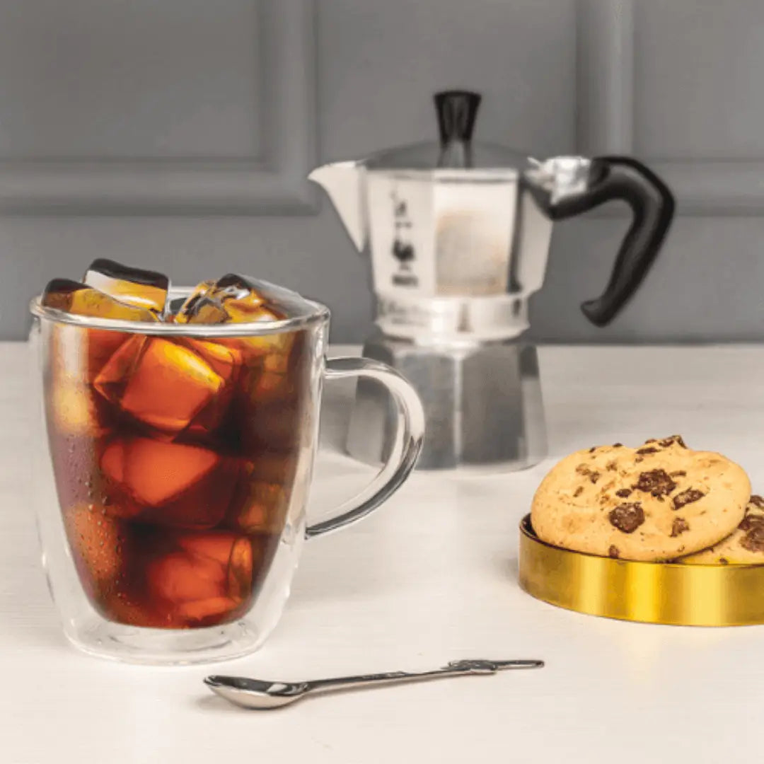 Two Brew Italia Capri double-walled glass mugs filled with coffee, showcasing sleek design and clear glass construction.