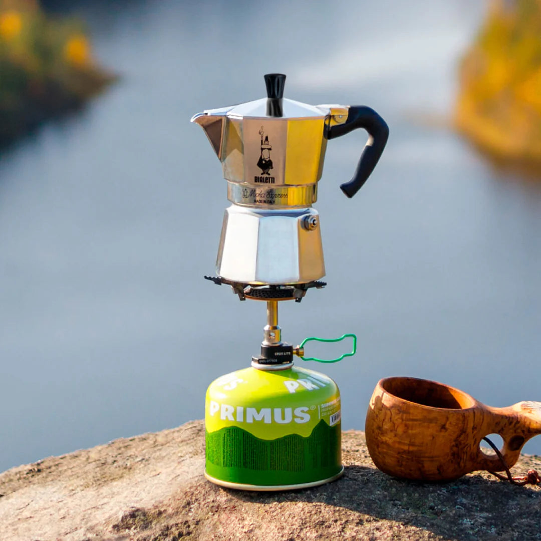 Bialetti Moka Express stovetop coffee maker for camping, made of aluminum with a black handle and lid for brewing espresso.