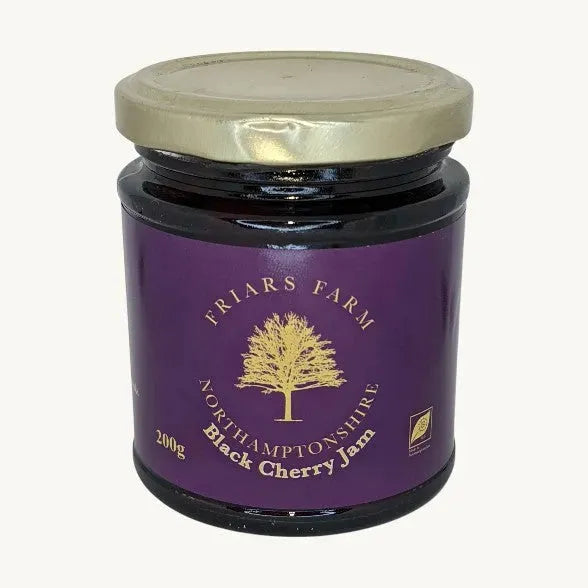 Close-up of Friars Farm Black Cherry Jam in a jar, showing dark cherry jam with a glossy texture and rich color.