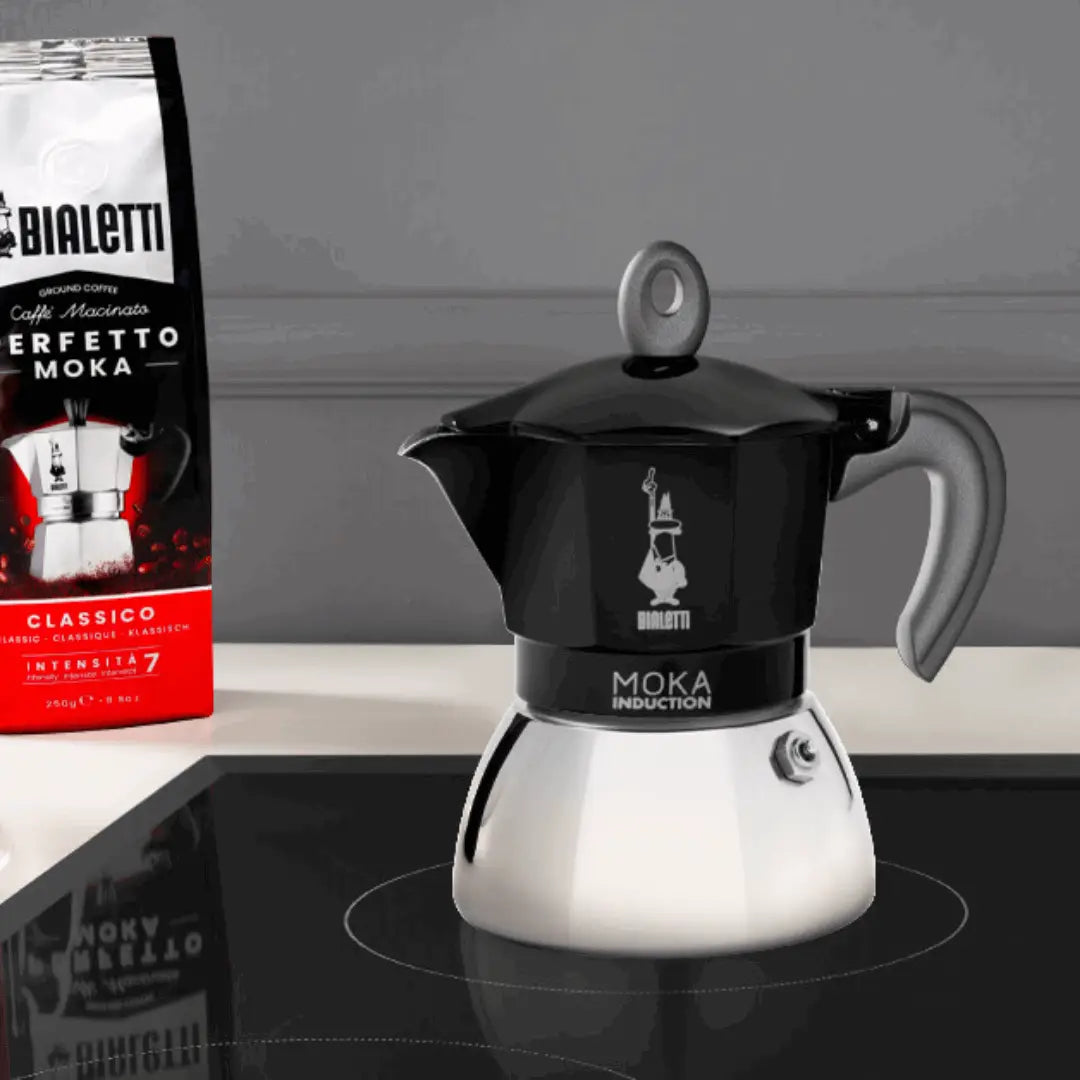 Black Bialetti Moka Induction stovetop coffee maker by Brew Italia, with a sleek design for brewing espresso-style coffee.