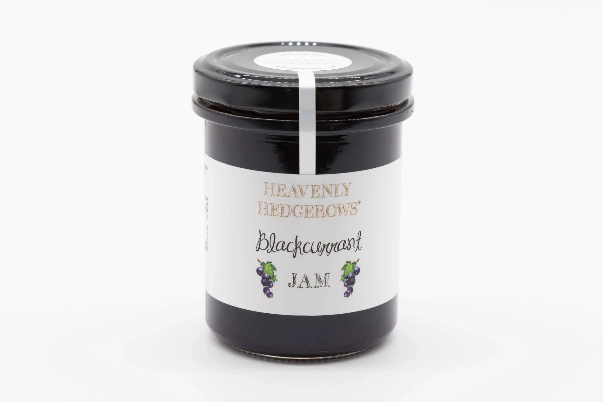 Heavenly Hedgerows Blackcurrant Jam jar with dark purple jam visible inside and fresh blackcurrants around it.