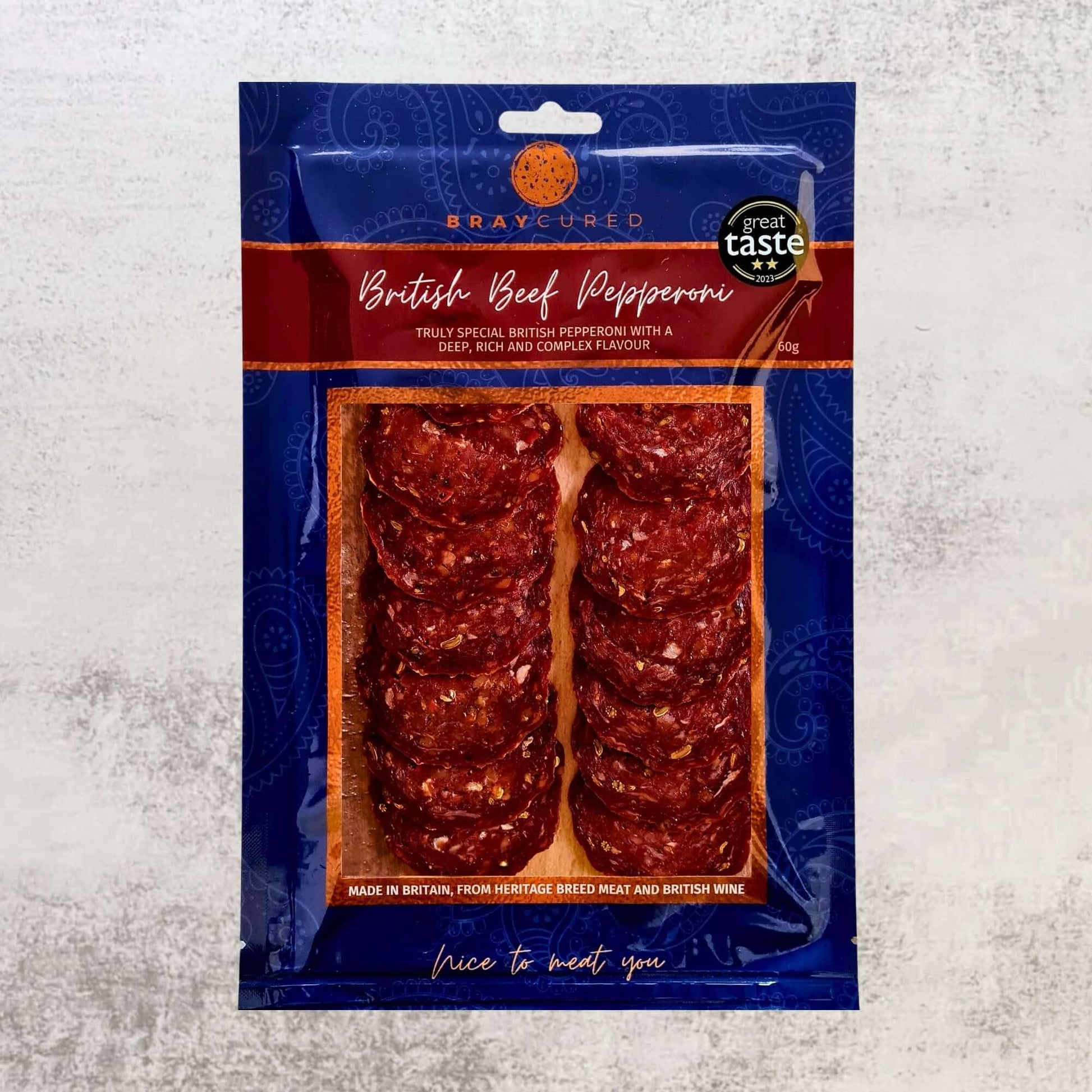 Bray Cured Spicy Feasting Five charcuterie selection with British beef pepperoni pack, showcasing sliced cured meats on a white background.