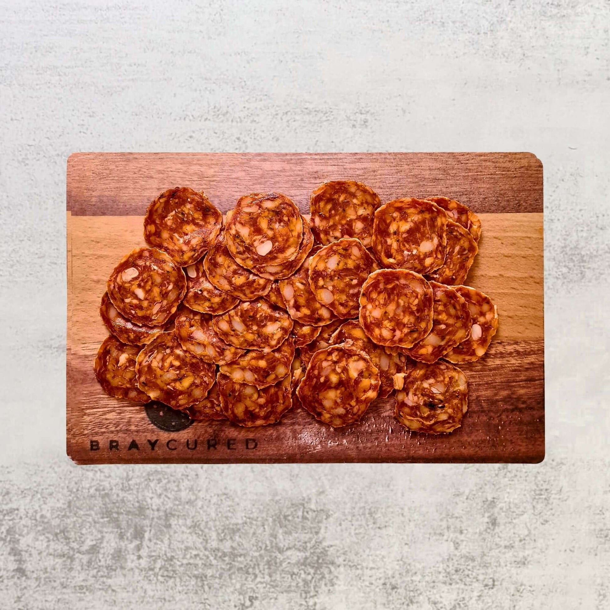 Sliced Bray Cured British chorizo on a charcuterie board, showcasing the personal salami selection with vibrant meat slices.