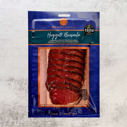 Thin slices of Bray Cured Hogget Bresaola charcuterie pack with cured, air-dried meat on a white background.