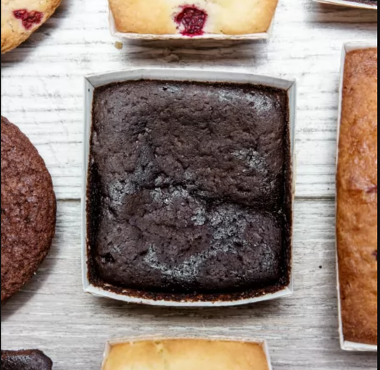 Vegan Super Dark Brownies from The Healthy Cake Company, rich and fudgy chocolate dessert with a dark, glossy appearance.