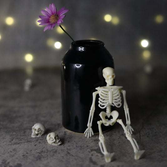 Jet black classic bud vase by Katie L Thompson Designs, featuring a sleek, minimalist ceramic shape perfect for floral arrangements.