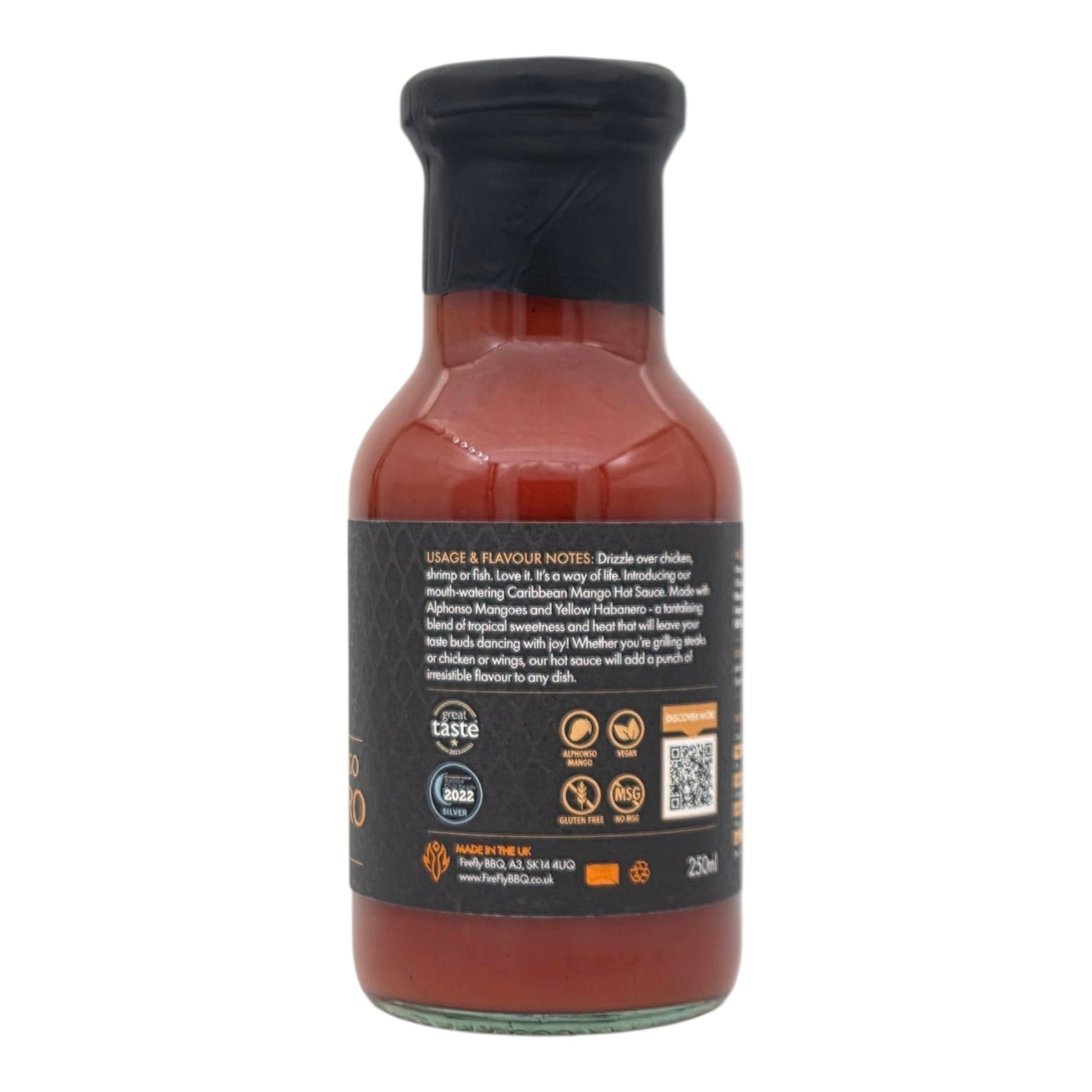 FireFly Barbecue Caribbean Mango Hot Sauce bottle showcasing vibrant label and orange sauce inside, perfect for grilling and flavoring.