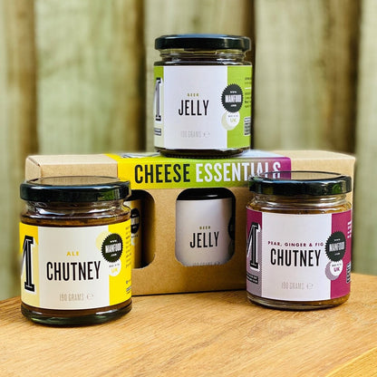 Manfood Cheese Essentials gift box with assorted chutneys and jellies, featuring colorful jars and elegant packaging.