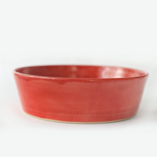 Cherry red classic pasta bowl by Katie L Thompson Designs, featuring a smooth, round shape and vibrant red glaze.