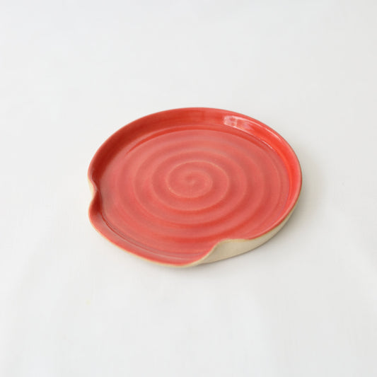 Cherry red ceramic spoon rest from Katie L Thompson Designs featuring a classic, rounded shape and smooth finish.