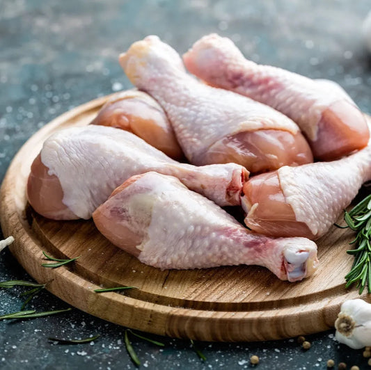 Primrose Herd Creedy Carver free-range chicken drumsticks showing raw, skin-on poultry ready for cooking.