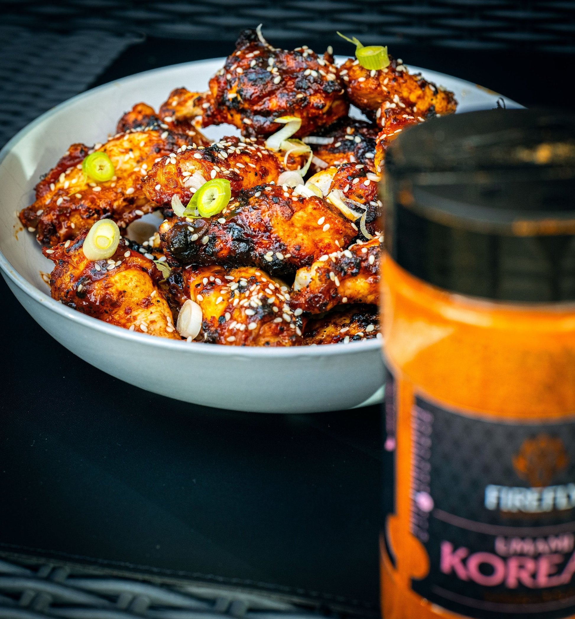 FireFly Barbecue Korean UMAMI BBQ Rub on chicken wings, highlighting flavorful seasoning for grilling or baking.