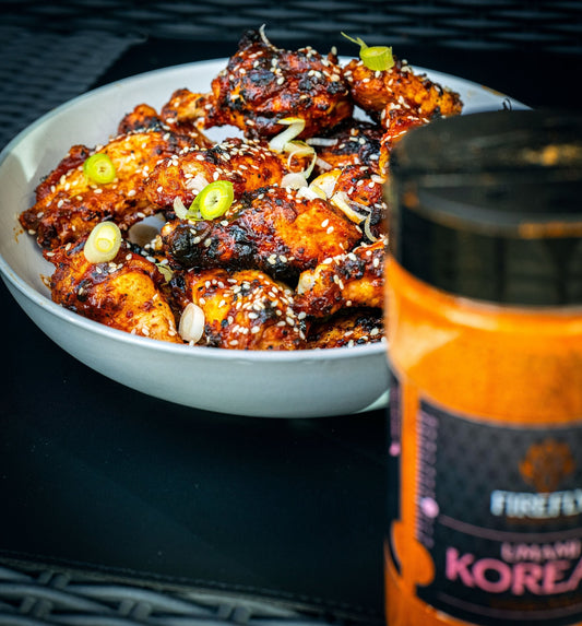 FireFly Barbecue Korean UMAMI BBQ Rub on chicken wings, highlighting flavorful seasoning for grilling or baking.