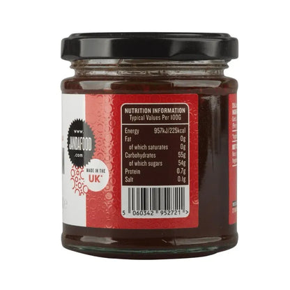 Janda chili jam jar with red chili peppers and label, showcasing vibrant, spicy chili jam in a clear glass jar.