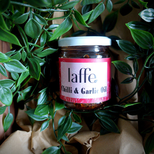 Jar of 'laffe Chilli & Garlic Oil' surrounded by green leaves
