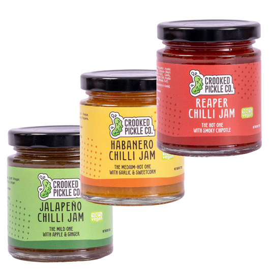 Crooked Pickle Co chilli jam trio jars with vibrant labels showcasing spicy fruit preserves and heat level indicators.