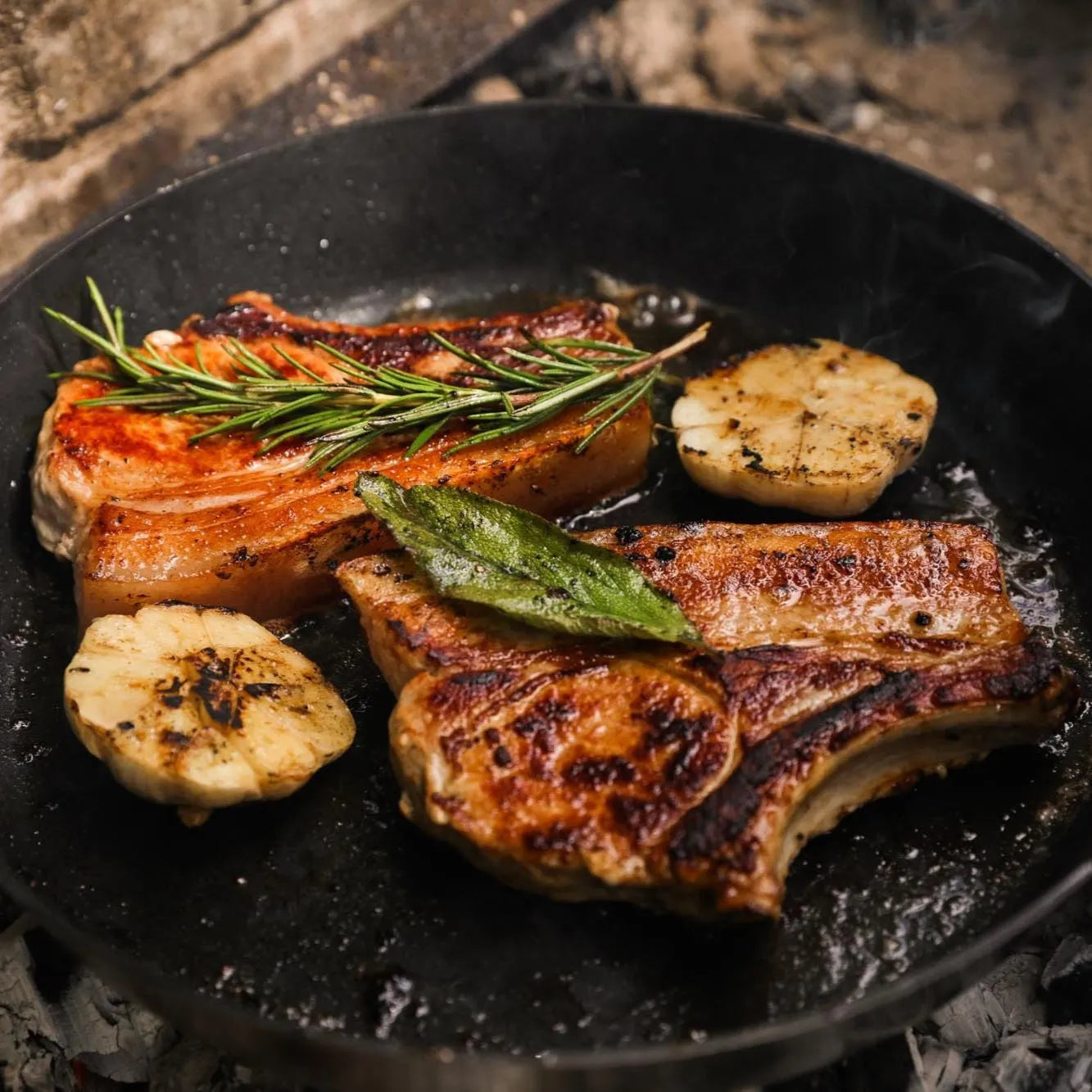 Pan-fried Primrose Herd pork chops in a skillet, showing juicy, cooked 500g pork chops with a golden crust.