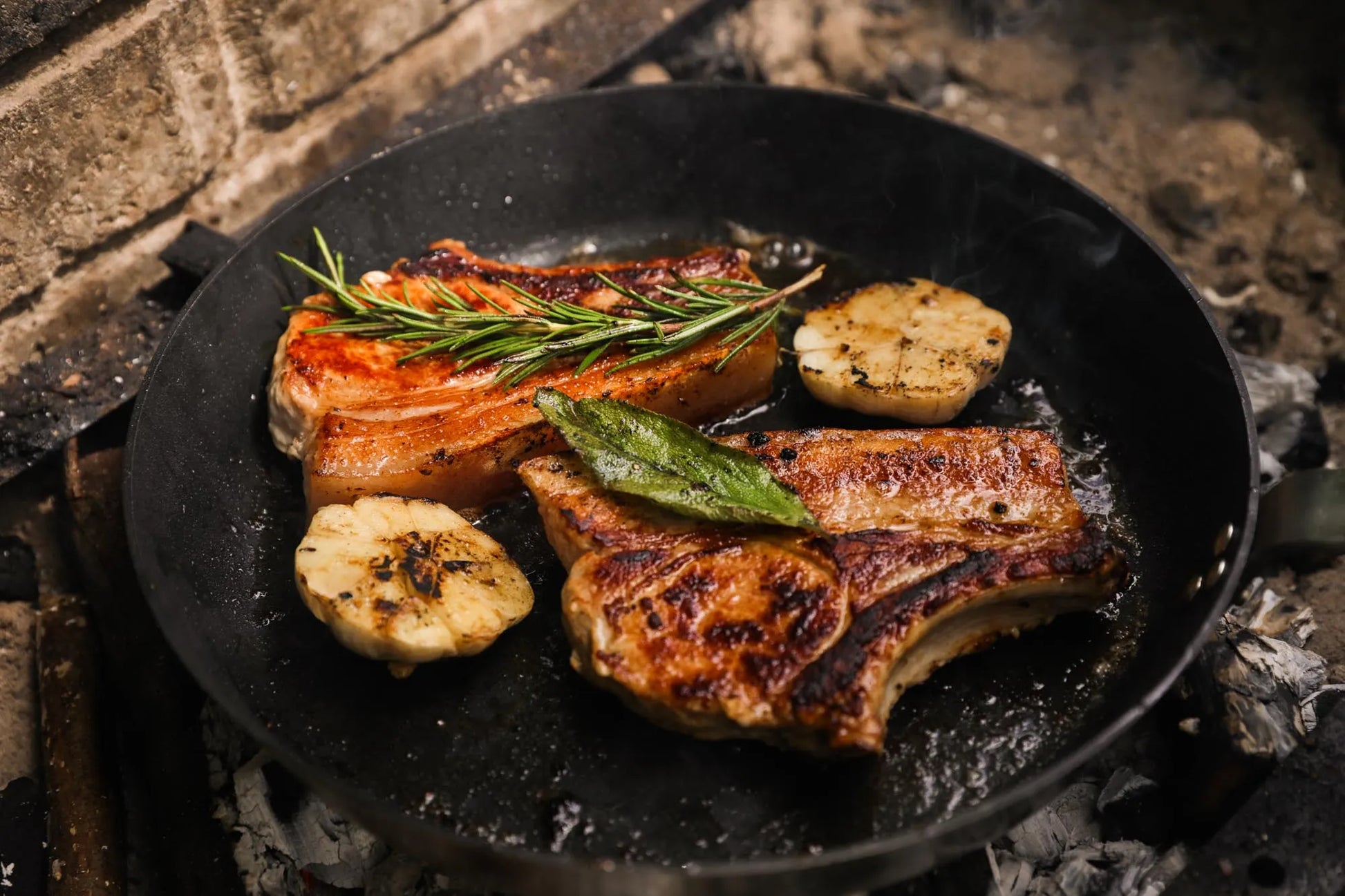 Pan-fried pork chops from the Primrose Herd Family Pork Box, showcasing juicy, cooked meat in a skillet.
