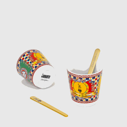 Bialetti X Dolce&Gabbana Sicilian Cart gift set featuring a 2-cup moka pot, two coffee cups, and gold stirrers for coffee lovers.