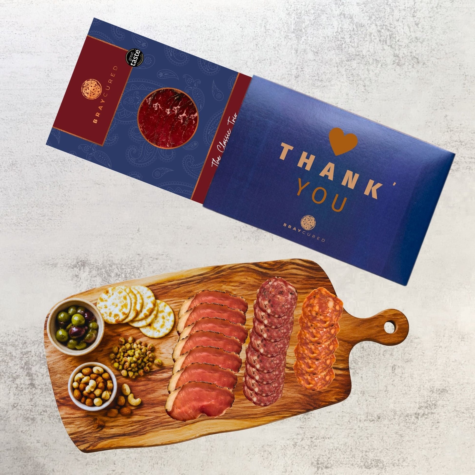 Bray Cured Classic Tasting Trio charcuterie selection featuring cured meats and cheeses on a wooden board.