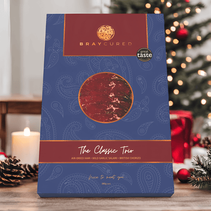 Assorted charcuterie selection from Bray Cured's Classic Tasting Trio with meats arranged on a festive Christmas scene.