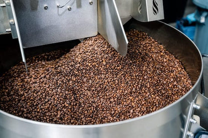 Dark roast heavyweight blend coffee from Clubhouse Roastery cooling on a coffee roaster’s cooling tray.
