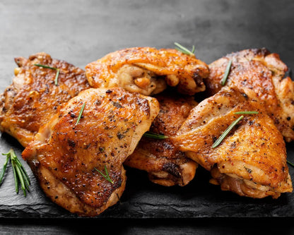 Cooked Creedy Carver free-range boneless chicken thighs from Primrose Herd, showing juicy, browned chicken thighs on a plate.
