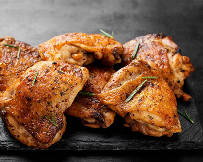 Cooked Primrose Herd Creedy Carver free-range bone-in chicken thighs, showing juicy, tender meat on the bone.