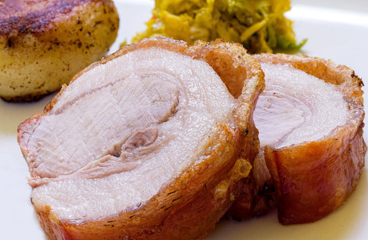 Cooked French Trimmed Loin of Pork joint from Primrose Herd, showcasing a golden-brown roasted pork loin with crispy edges.