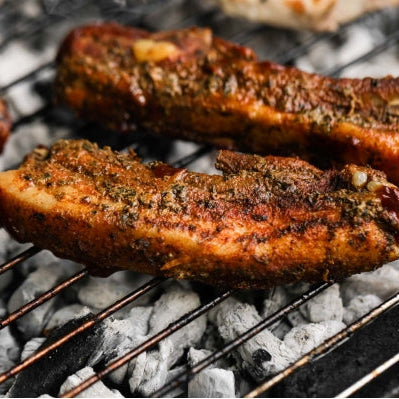 Cooked pork ribs from Primrose Herd, 500g, showing tender, glazed pork ribs ready to serve.