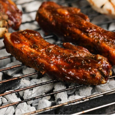 Cooked Primrose Herd pork ribs, 500g, showing juicy, glazed ribs with tender meat and smoky seasoning.