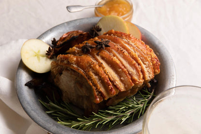 Cooked pork shoulder joint from Primrose Herd, showcasing a juicy, tender collar joint ready for serving.