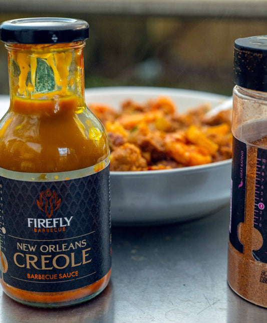FireFly Barbecue New Orleans Creole Sauce in a jar, showcasing vibrant red Creole-style BBQ sauce with herbs and spices.