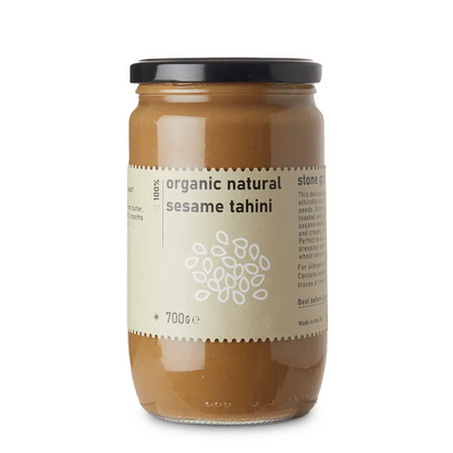 Organic Natural Sesame Tahini dip by Whole Food Earth, showing a creamy, beige sesame spread in a jar with a spoon.