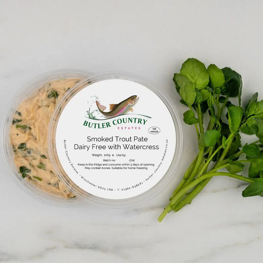 Dairy-free smoked trout pâté with watercress served on a plate, showcasing fresh ingredients and smooth texture.