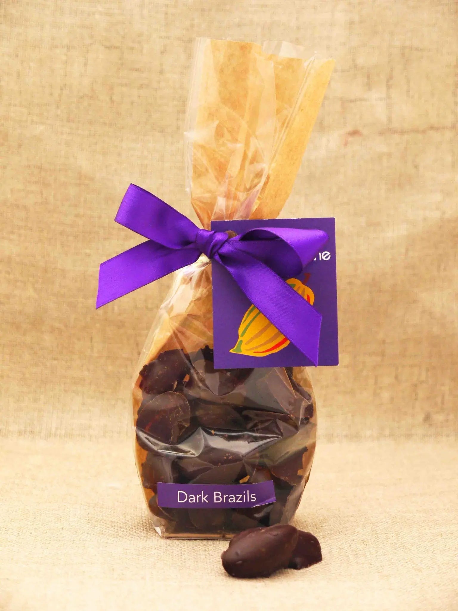 Assorted Brazil nuts covered in milk chocolate from Gorvett & Stone in a clear bag.