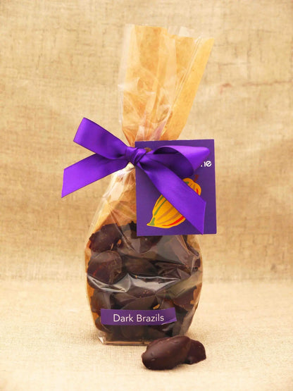 Assorted Brazil nuts covered in milk chocolate from Gorvett & Stone in a clear bag.