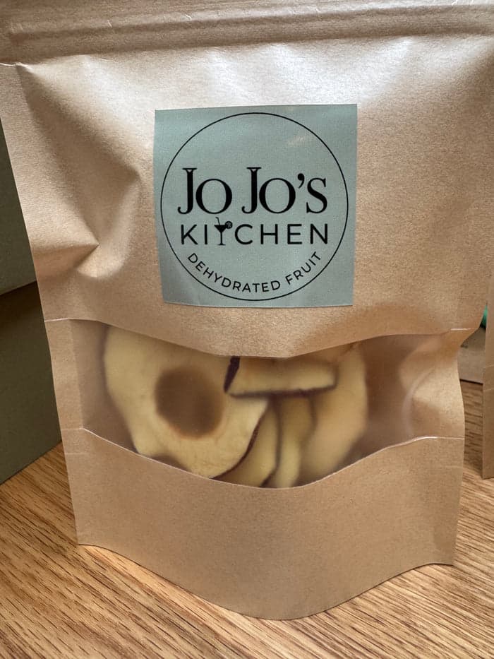 Dehydrated apple crisps from JoJo’s Kitchen, crispy apple snack slices in a clear bowl, ready to enjoy a healthy treat.