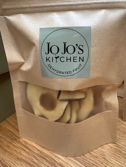 Dehydrated apple crisps from JoJo’s Kitchen, crispy apple snack slices in a clear bowl, ready to enjoy a healthy treat.