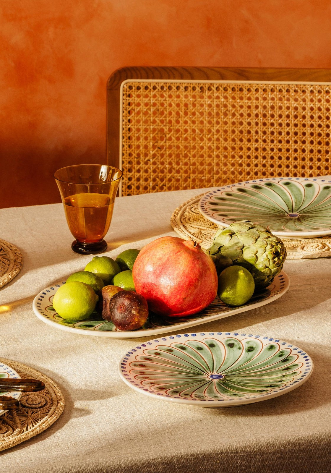 Set of four green Casa by Josephine Jenno Peacock dinner plates with intricate peacock feather designs.