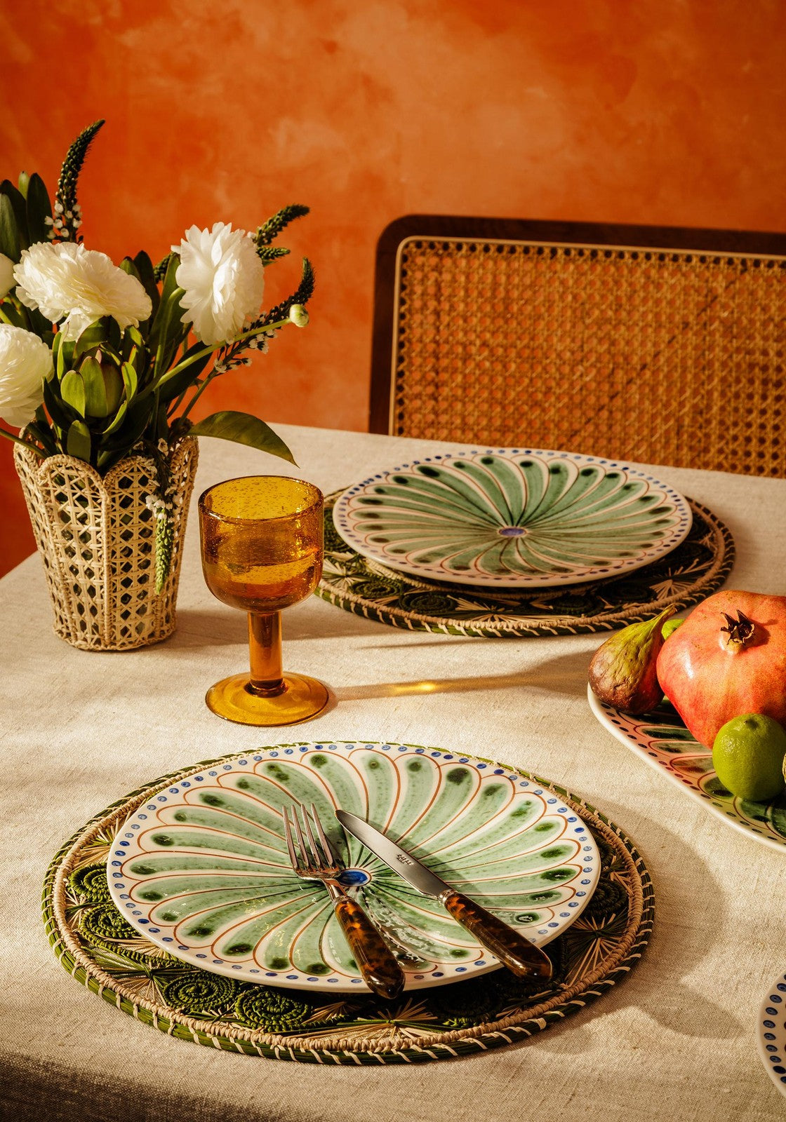 Set of four green Casa by Josephine Jenno Peacock dinner plates with intricate peacock feather designs.