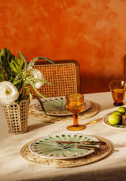 Set of four green Casa by Josephine Jenno Peacock dinner plates with intricate peacock feather designs.