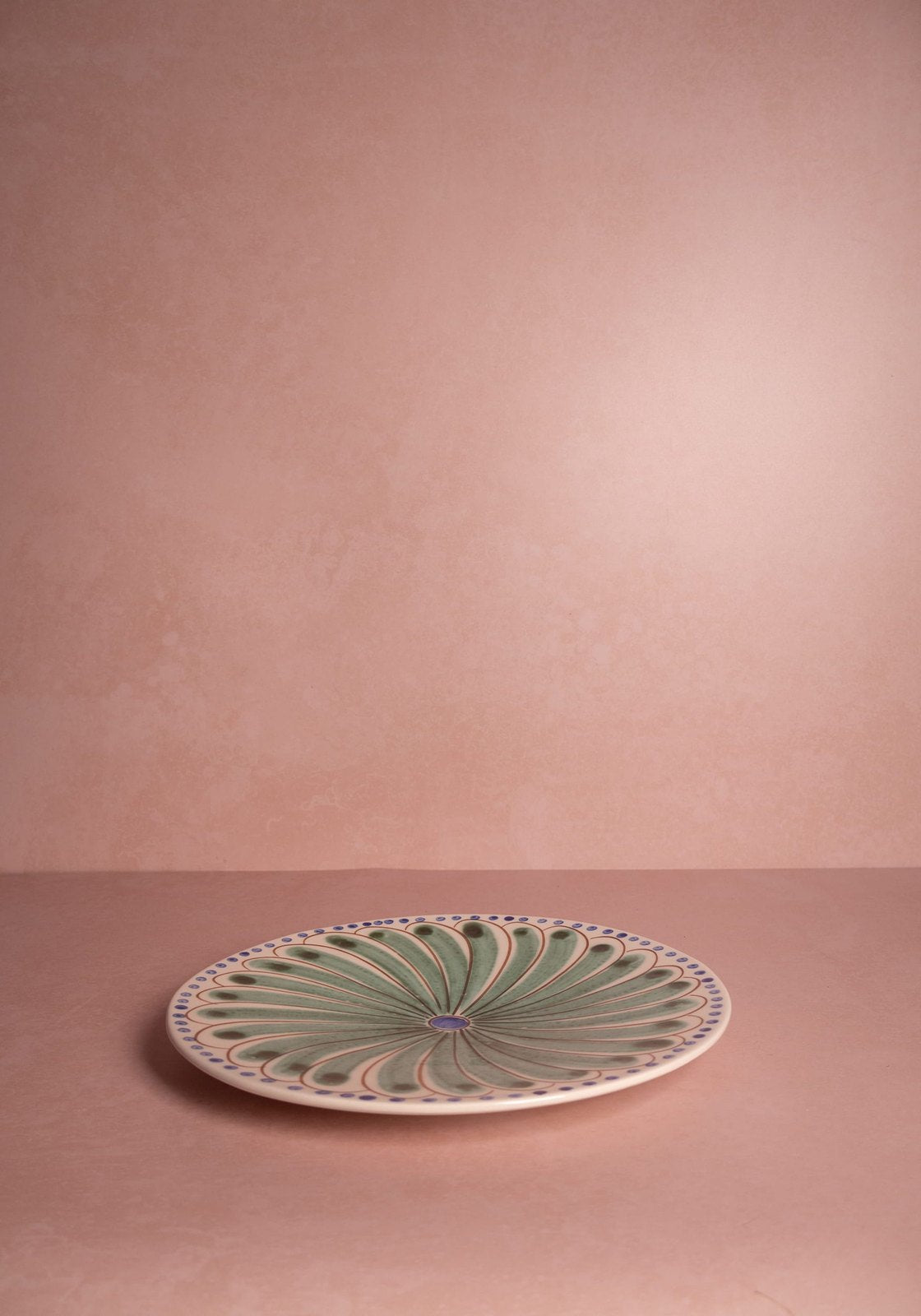 Set of four green Casa by Josephine Jenno Peacock dinner plates with intricate peacock feather designs.