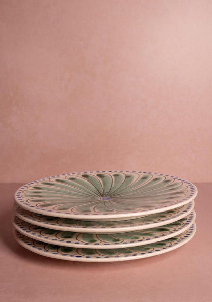 Set of four green Casa by Josephine Jenno Peacock dinner plates with intricate peacock feather designs.