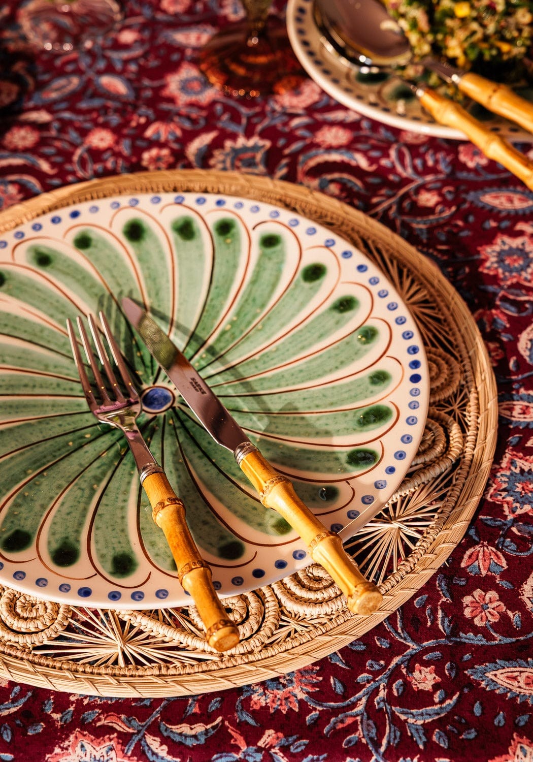 Set of four green Casa by Josephine Jenno Peacock dinner plates with intricate peacock feather designs.