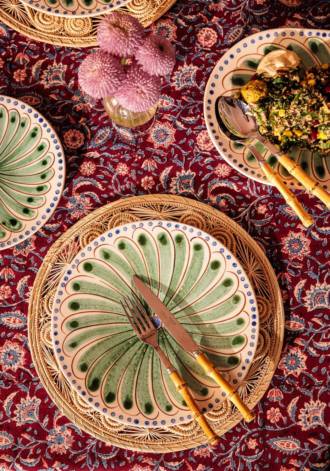 Set of four green Casa by Josephine Jenno Peacock dinner plates with intricate peacock feather designs.
