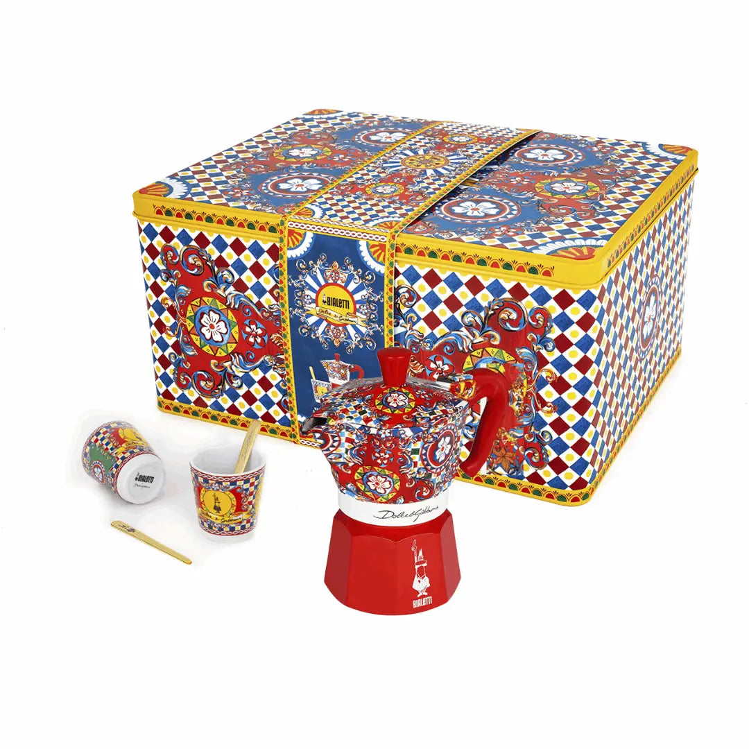 Bialetti X Dolce&Gabbana Sicilian Cart gift set with 2-cup moka coffee maker, 2 cups, and gold stirrers, featuring vibrant holiday packaging.