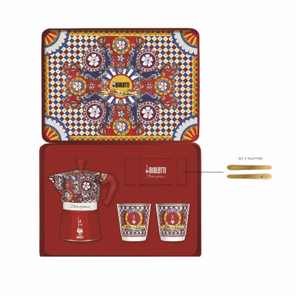 Bialetti X Dolce&Gabbana Sicilian Cart gift set featuring a 2-cup moka pot, two cups, and gold stirrers on festive packaging.